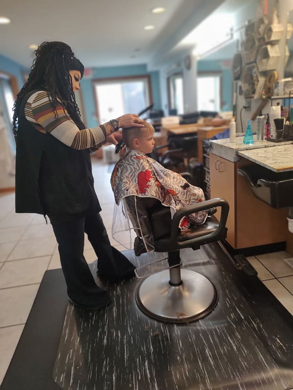 young boy getting hair cut by Alana Murdock